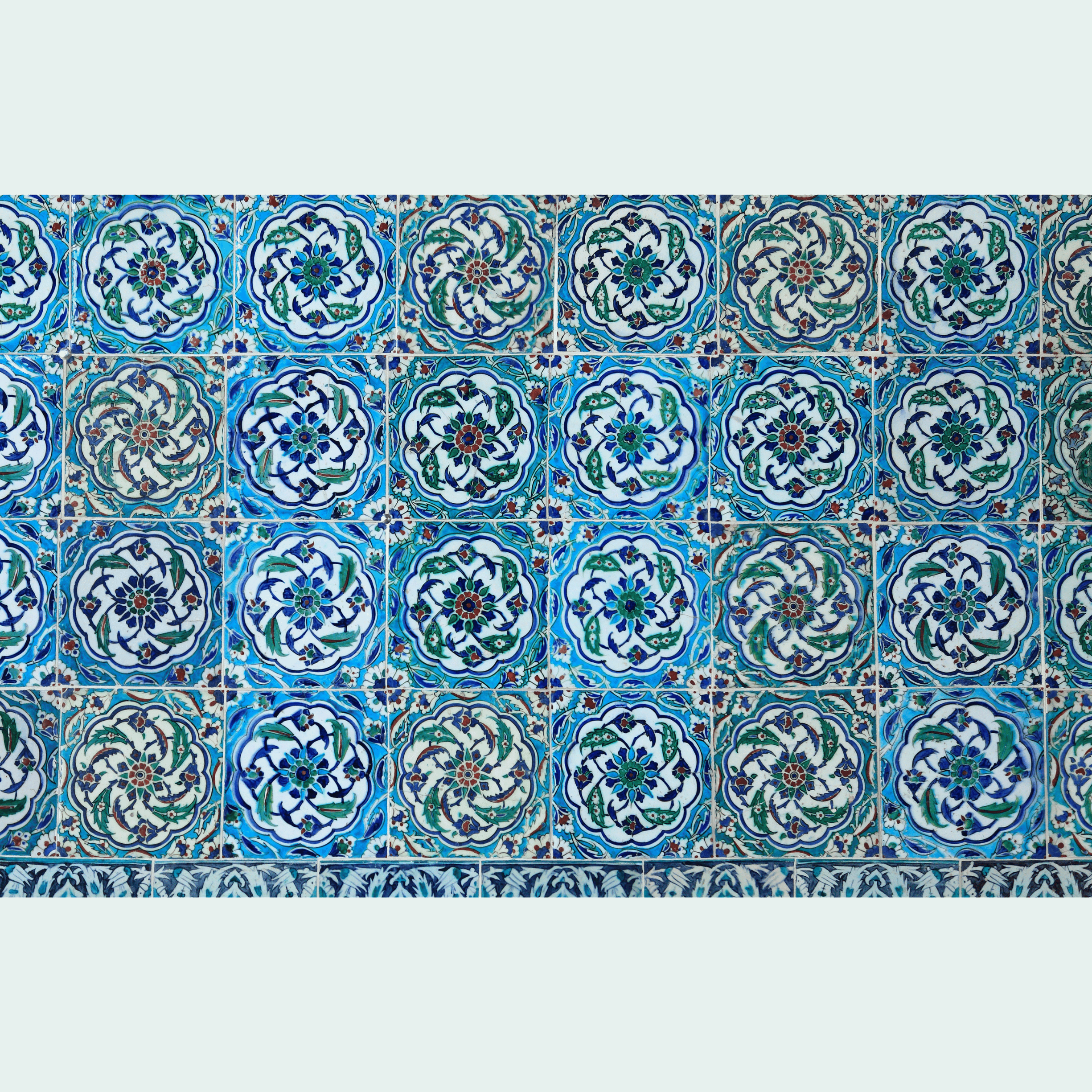 Iznik tile wall with repeating blue and turquoise medallion motifs
