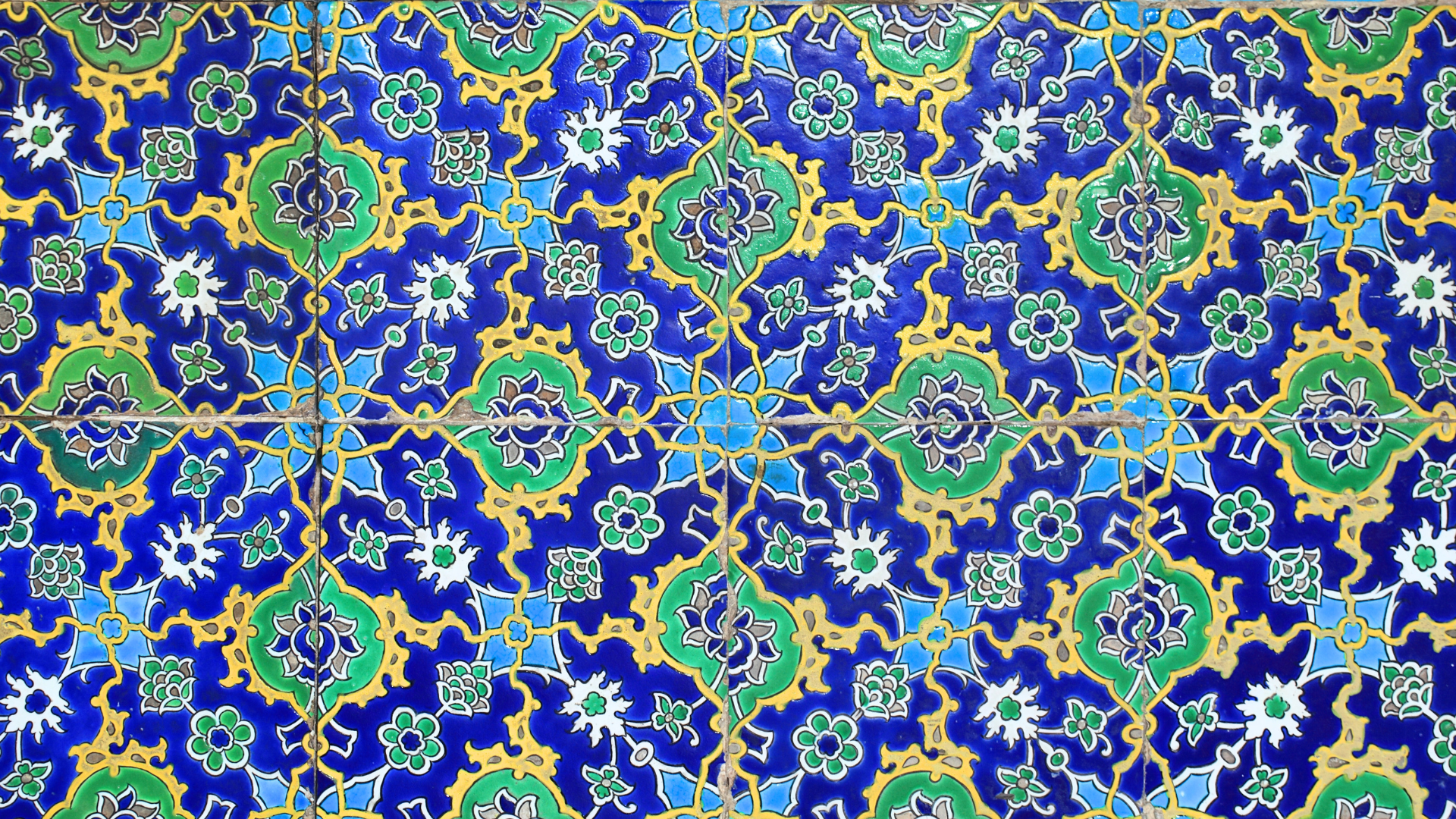 Hand-painted Islamic tiles — cobalt blue, gold and turquoise floral composition